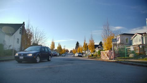 A-Car-Slowly-Drives-Across-The-Road-In-A-Quiet-Neighbourhood