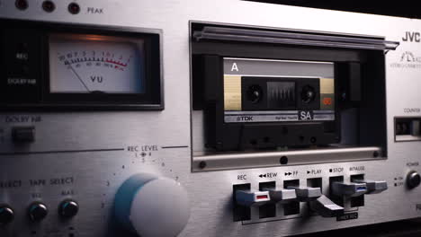 Playback-of-Audio-Cassette-Tape-in-Vintage-Deck-Player-With-VU-Meters,-Close-Up