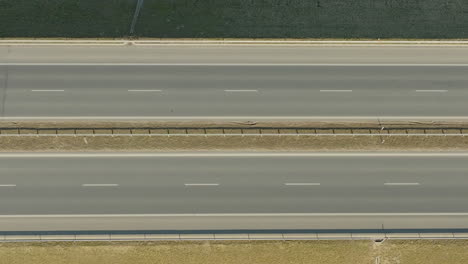 Top-down-view-of-a-car-driving-on-a-highway-with-clear-lane-markings