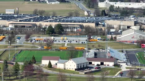 American-Yellow-School-bus-at-Warwick-School-District-with-soccer-and-football-field