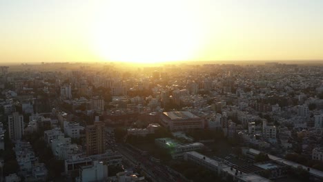 Aerial-drone-view-going-down-showing-a-large-temple-and-many-houses-and-complexes-around