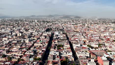 Lateral-drone-shot-of-downtown-mexico-city-and-zocalo