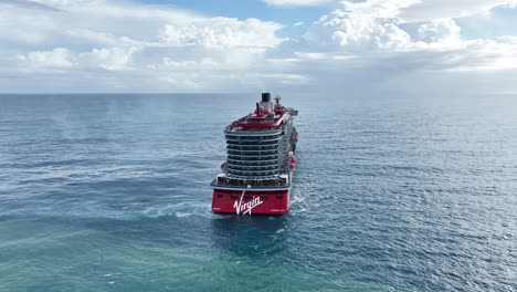 Flying-over-large-cruise-ship-navigating-in-open-ocean