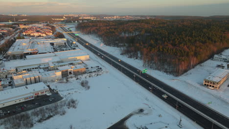 Aerial-View-Of-Vehicles-Driving-Through-Highway-During-Winter-In-Dabrowa,-Poland