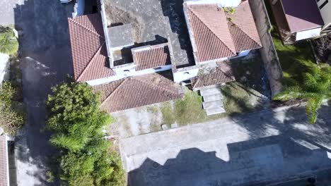 Abandoned-two-story-white-house-with-red-tiles