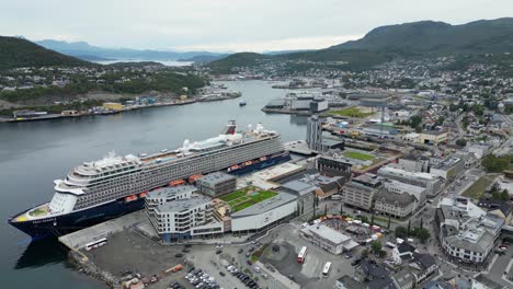 Aerial-View-of-Harstad-Norway-Harbour,-Cruise-Ship-at-Terminal-and-Bay,-Drone-Shot