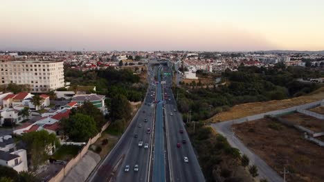 Aerial-birds-eye-shot-of-busy-highway-in-Puebla-City-at-dusk