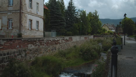 Small-European-town-with-stream-running-through-in-mountain-countryside,-Poland
