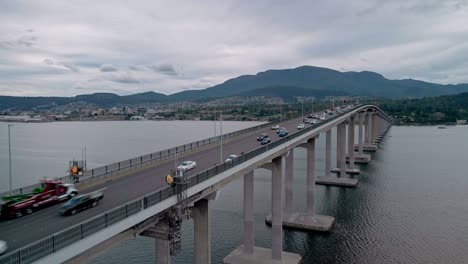 Aerial-tilt-up-shot-of-a-bridge-on-a-cloudy-day-in-Hobart,-Tasmania-Australia