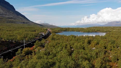 Aerial:-ore-train-by-a-lake-in-northern-Sweden