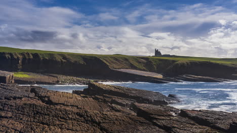 Timelapse-of-rugged-rocky-coastline-on-sunny-cloudy-day-with-Classiebawn-castle-in-distance-in-Mullaghmore-Head-in-county-Sligo-on-the-Wild-Atlantic-Way-in-Ireland