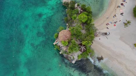 Top-down-drone-footage-a-beach-with-people-on-Siquijor-in-the-Philippines