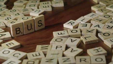 Narrow-focus-closeup:-Hand-makes-word-BUSINESS-from-game-tile-letters