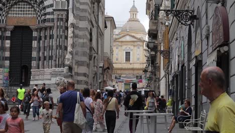 Slow-motion-clip-of-busy-crowds-walking-through-Piazza-San-Lorenzo-in-Genoa,-Italy