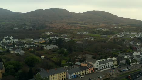Aerial-pullback-of-Roundstone-town-in-Connemara-featuring-the-mountains-in-the-background