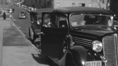 Woman-in-Luxury-Clothes-Load-a-Dog-into-a-Classic-Car-in-New-York-City-in-1930s