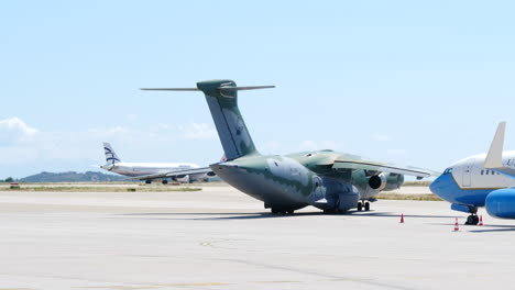 Tracking-shot-of-Embraer-Millennium-plane-taxiing-at-Athens-airport-on-sunny-day