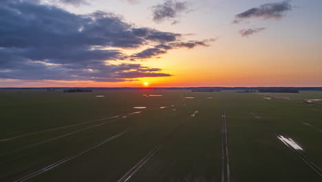 Farmland-crops-under-a-golden-sunset---cloudscape-aerial-hyper-lapse