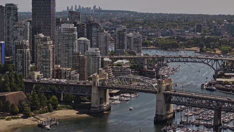 Vancouver-BC-Canada-Aerial-v122-zoomed-view-drone-flyover-False-creek-capturing-traffics-on-Burrard-Street-Bridge-and-concrete-jungle-downtown-cityscape-views---Shot-with-Mavic-3-Pro-Cine---July-2023