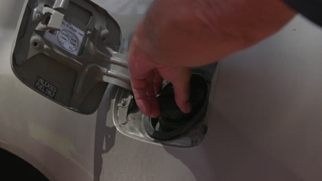 Opening-the-fuel-cap-on-a-motor-vehicle