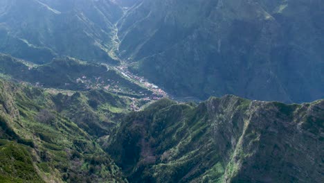 Madeira-village-settlement-by-lush-sharp-mountain-ridge-edge