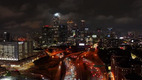 Timelapse-of-Downtown-Atlanta-highway-traffic-at-night-under-cloudy-sky,-Georgia,-USA
