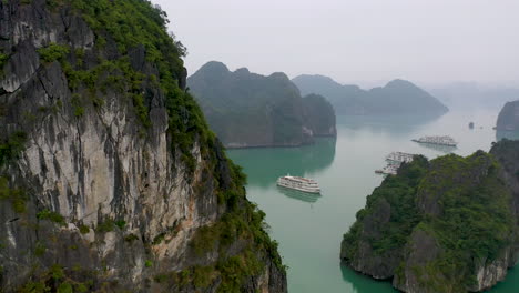 Aerial-view-of-tourist-boats-cruising-through-picturesque-Halong-Bay,-Vietnam