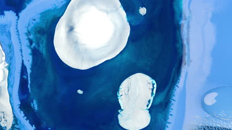 Pullback-rising-from-blue-shiny-ink-with-white-circle-in-abstract-ocean-liquid-pattern