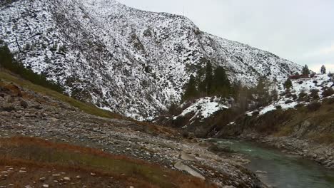 Snow-Covered-Mountains-And-River,-Boise-National-Forest-In-Idaho,-United-States---Tilt-Up