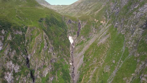 Verdant-Fagaras-Mountains-embracing-the-Valea-Rea-Waterfall,-aerial-view