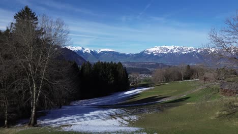 Toma-De-Drones-De-Cabañas-En-Las-Montañas-Con-Una-Vista-Increíble-Sobre-El-Paisaje-Montañoso-Invernal-Con-Montañas-Nevadas-En-Un-Día-Soleado-En-Austria