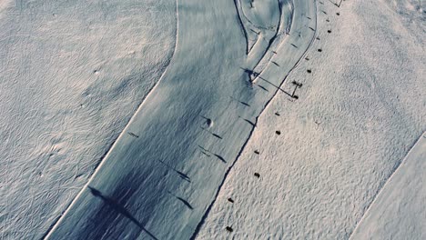 Above-chairlift-and-downhill-ski-slope-in-Austria,-aerial