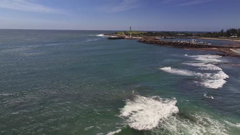 Aerial-reveal-over-the-surf-and-rocks-of-Wollongong-Harbour-and-the-light-houses
