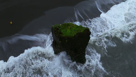 Ocean-Waves-Crashing-On-Sea-Stack-At-Laekjavik-Black-Sand-Beach-In-Iceland