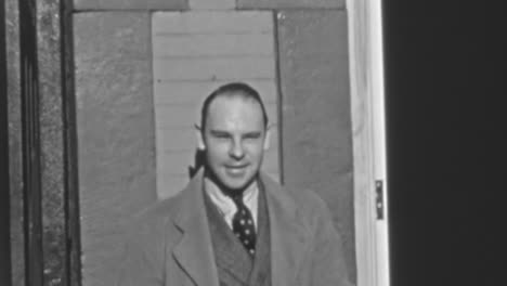 Man-in-Suit-Puts-on-a-Hat-on-a-New-York-City-Street-in-the-1930s