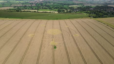 Combe-hill-crop-circle-intricate-spiral-pattern-aerial-view-circling-idyllic-Wiltshire-agricultural-wheat-field
