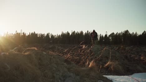 Person-With-Shovel-Digging-Soil-At-Sunset-In-Rural-Land