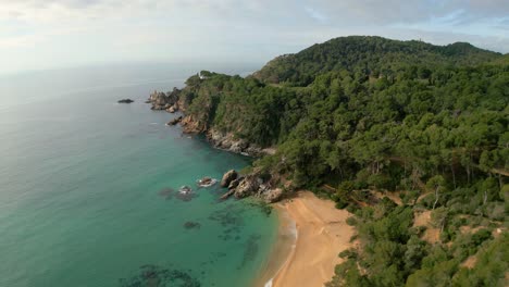 From-above,-witness-Lloret-De-Mar's-stunning-coastline-with-its-crystal-clear-waters,-inviting-sandy-beaches,-and-upscale-tourism-destinations-like-Santa-Cristina-and-Cala-Treumal