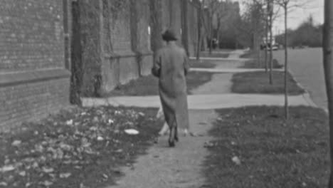 Elderly-Woman-Pays-to-a-Dog-Walker-on-Neighborhood-Street-in-1930s