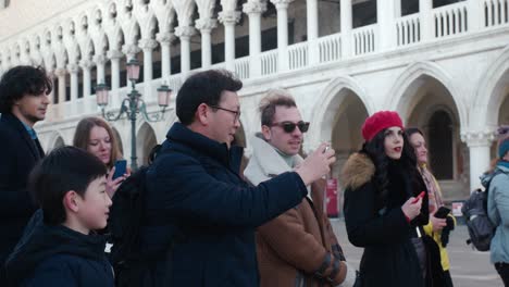 Tourists-enjoying-Venetian-architecture-and-taking-pictures