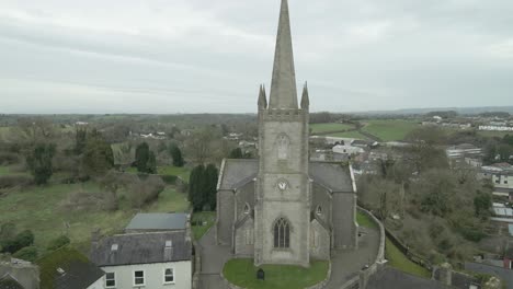 Clones-church-in-monaghan,-ireland,-overlooking-the-town,-with-overcast-skies,-aerial-view