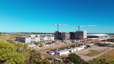 Aerial-view-above-southern-part-of-Montpellier-city-with-office-buildings-and-construction-sight-with-cranes