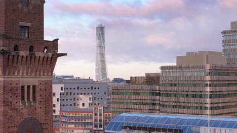 Aerial-reveal-of-Malmo-university-and-Turning-Torso-beyond-from-behind-Tornhuset