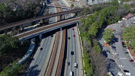 Drone-shot-of-busy-traffic-with-tracks-at-center