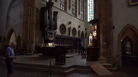 Two-People-Try-to-Tune-Wooden-Organ-of-St-Martin's-Church-while-Visitors-Watches-Them