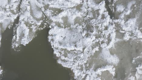 Icy-waters-near-Southampton-with-floating-ice-sheets-in-winter,-aerial-view