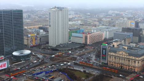 Traffic-moving-through-busy-roundabout-in-downtown-Warsaw,-Poland,-aerial-view