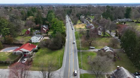 Driving-car-on-road-stopping-in-traffic-jam-on-scenic-road-in-american-suburb-neighborhood