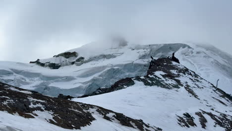 Ice-glacier-boulders-Saas-Fee-Saastal-Zermatt-glacier-mountain-peaks-ski-resort-Switzerland-Swiss-Alps-Alpine-Valley-autumn-fall-Platen-Alphabet-Taschorn-cloudy-fog-afternoon-landscape-slow-pan-left
