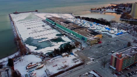 Port-Credit-Mississauga-with-boats-parked-for-the-winter-near-water---aerial